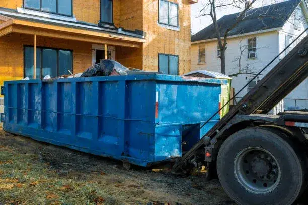 Residential roll-off dumpster on a driveway for a home project